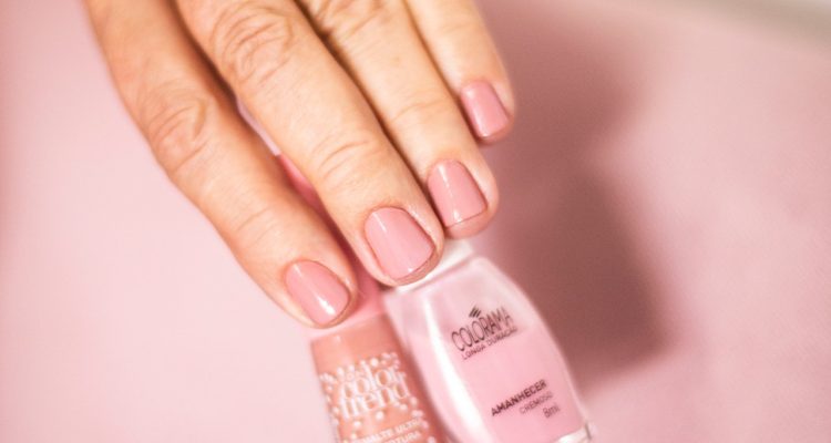person-holding-nude-color-nail-polish-2281695